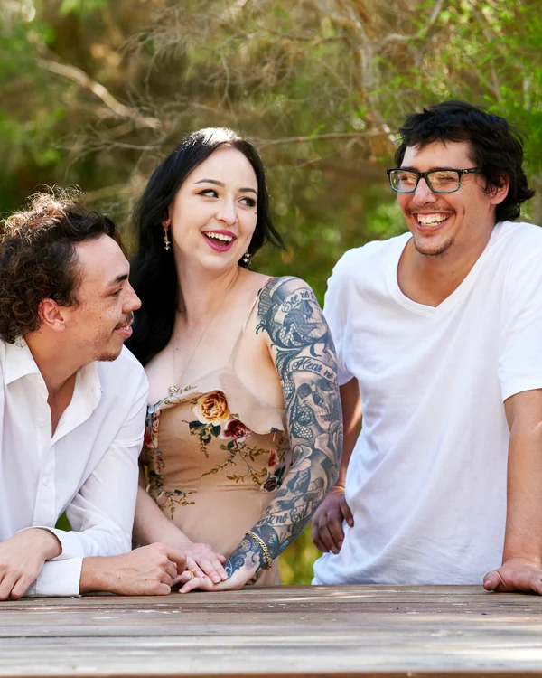 A large family photographed outdoors wearing white and denim
