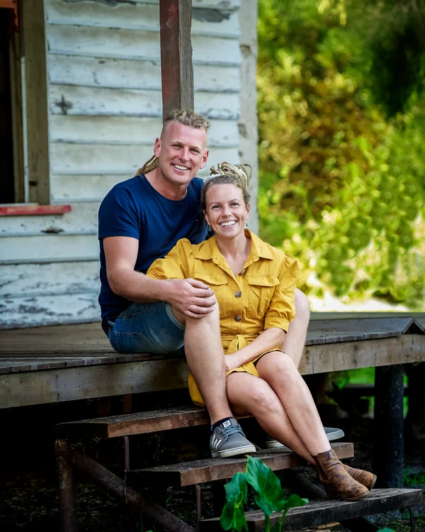 A large family photographed outdoors wearing bold colours