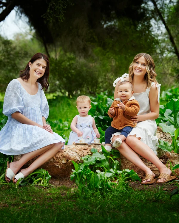 A large family photographed outdoors wearing white and denim
